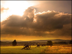 Sunrise silhouette of monument and cannon at Antietam Battlefield at Sharpsburg, Maryland, USA.