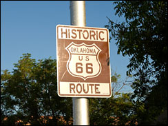 Historic Route 66 sign located along the road in Oklahoma. America's highway.