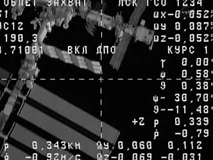 Cargo ship docks with space station; Soyuz issue assessed